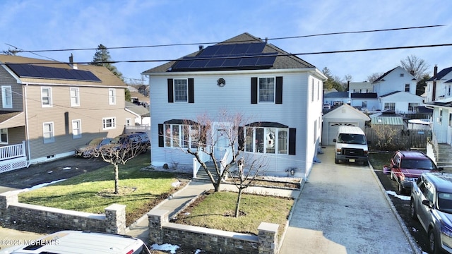 view of front of home with solar panels and a front yard