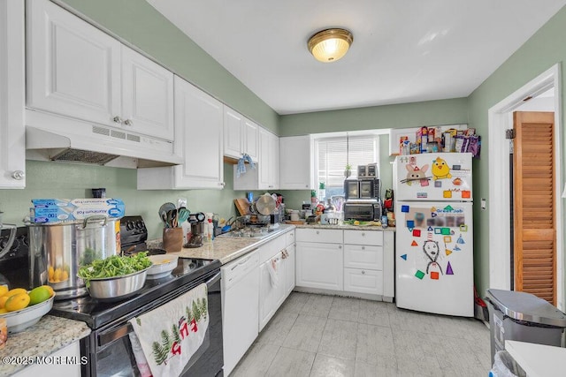 kitchen with sink, white appliances, and white cabinetry