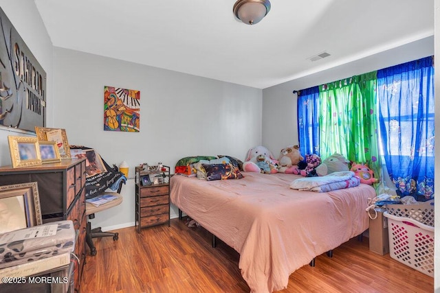 bedroom with wood-type flooring