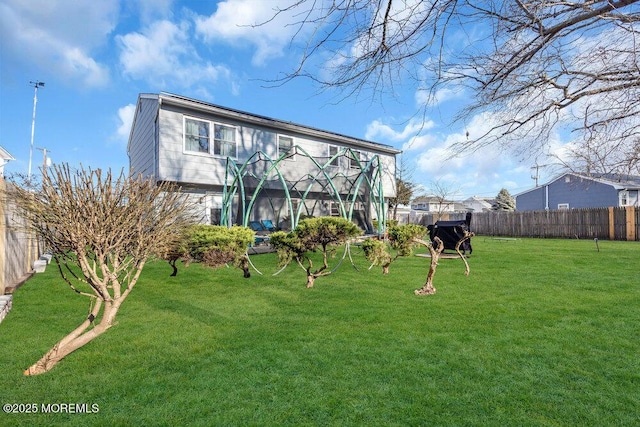 back of house featuring a yard