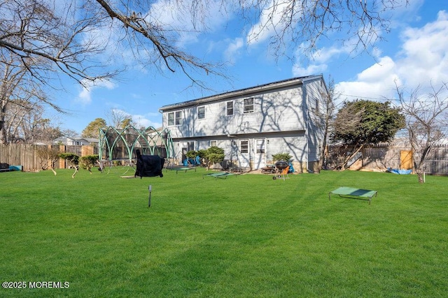 back of house featuring a lawn