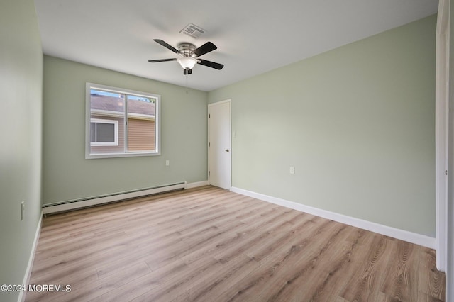 spare room with a baseboard heating unit, ceiling fan, and light hardwood / wood-style flooring