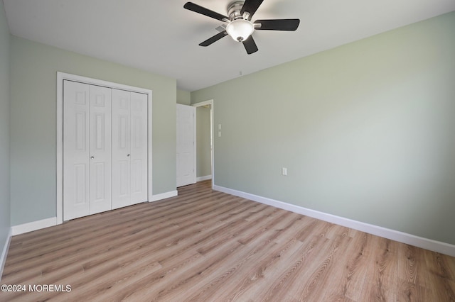 unfurnished bedroom featuring a closet, ceiling fan, and light hardwood / wood-style flooring