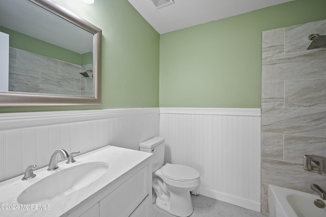 full bathroom featuring toilet, vanity, and tiled shower / bath