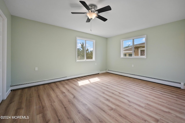 empty room featuring light wood-type flooring, ceiling fan, and a baseboard radiator