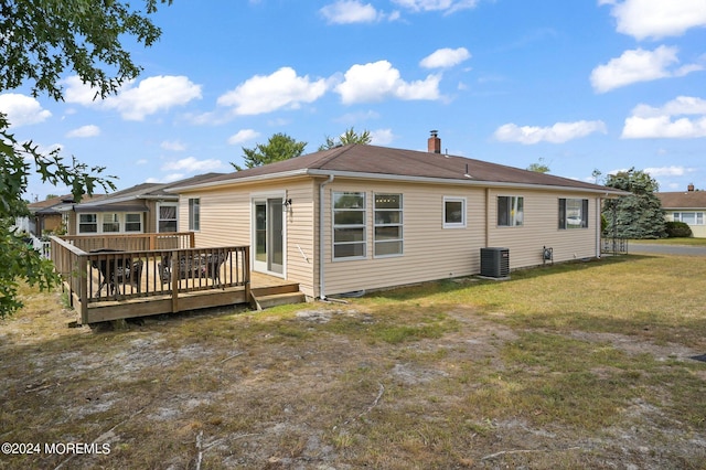 back of property featuring a deck, a yard, and central AC