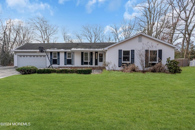 ranch-style home featuring a porch, a front yard, and a garage