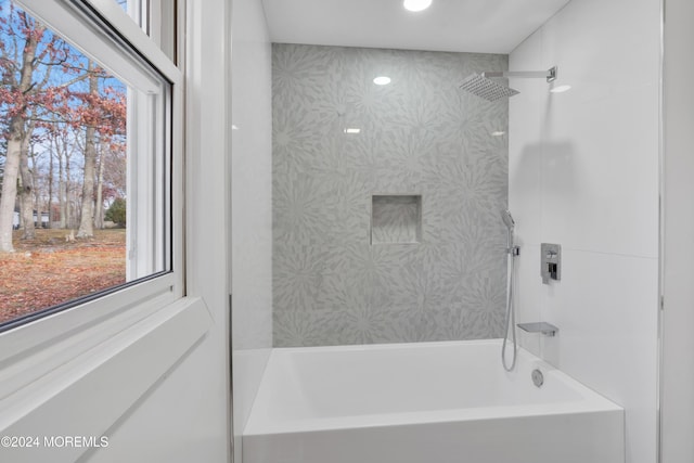 bathroom with tiled shower / bath combo and plenty of natural light