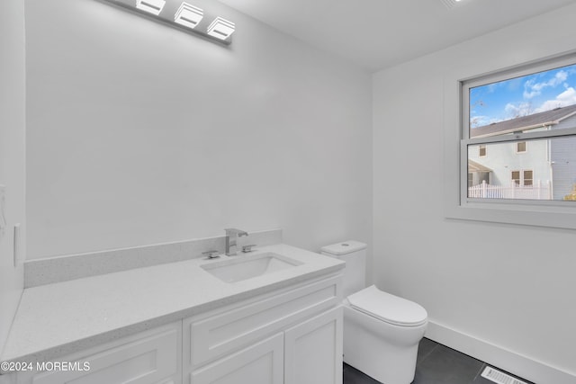 bathroom featuring toilet, tile patterned floors, and vanity