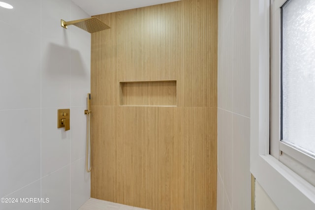 bathroom with tiled shower