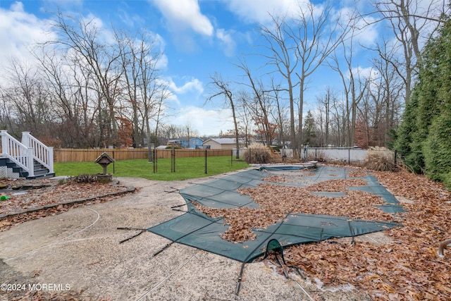 exterior space with a patio area and a covered pool