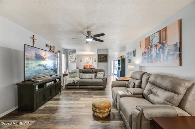 living room with a textured ceiling, ceiling fan, and wood-type flooring