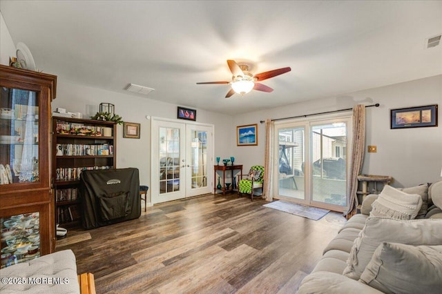 living room with ceiling fan, french doors, and dark hardwood / wood-style floors