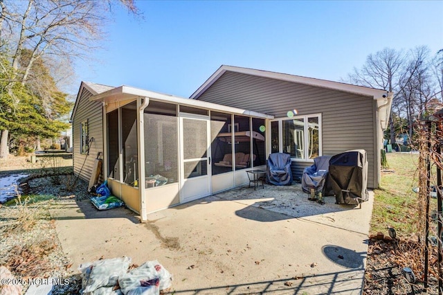 back of house featuring a patio and a sunroom