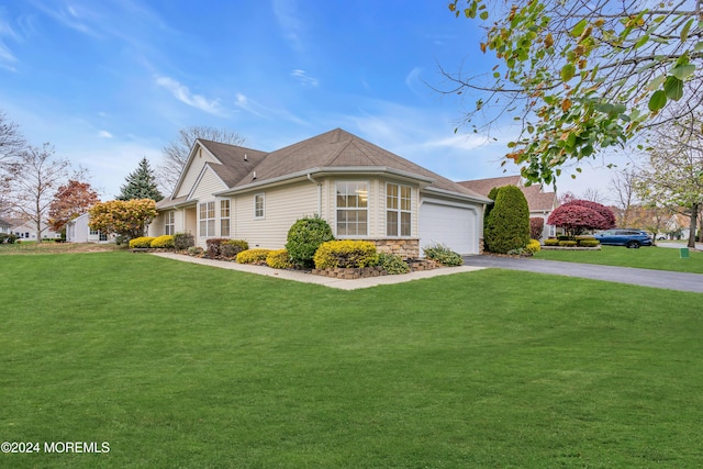 view of front of property with a garage and a front lawn