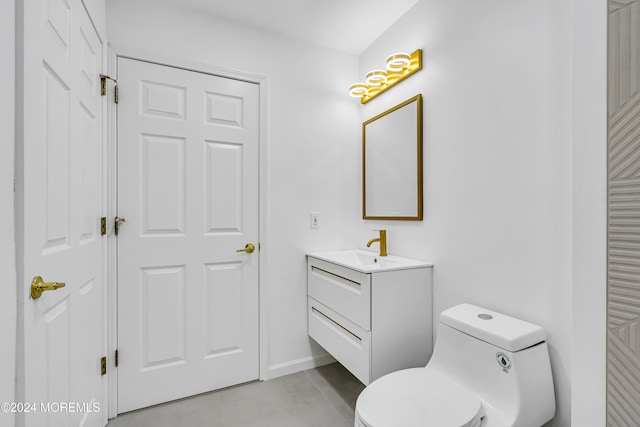 bathroom with tile patterned floors, vanity, and toilet