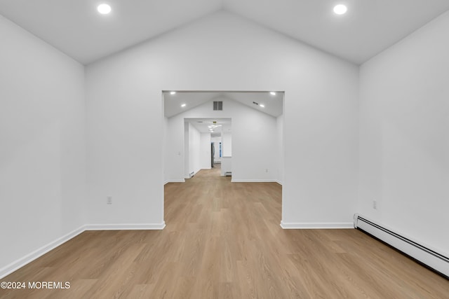 unfurnished living room featuring lofted ceiling, baseboard heating, and light hardwood / wood-style flooring