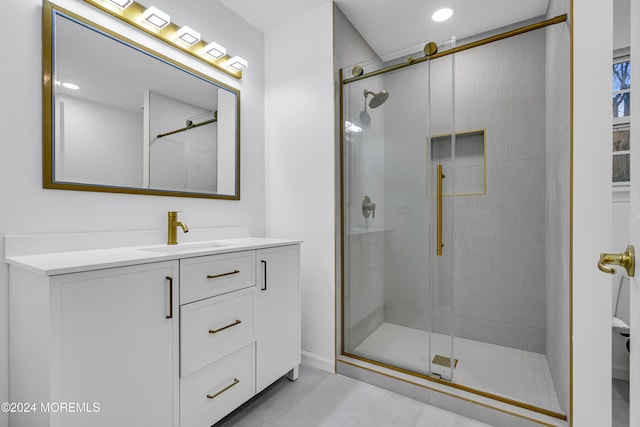 bathroom featuring an enclosed shower and vanity