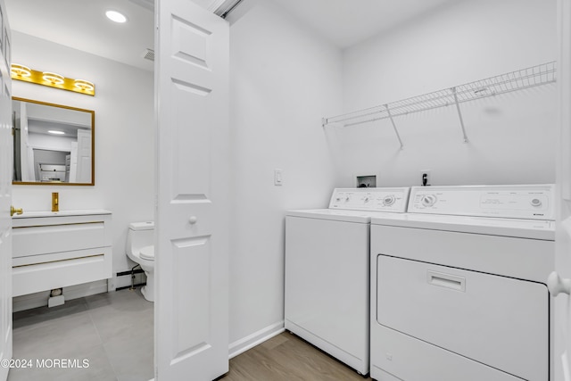 washroom with sink and washer and clothes dryer