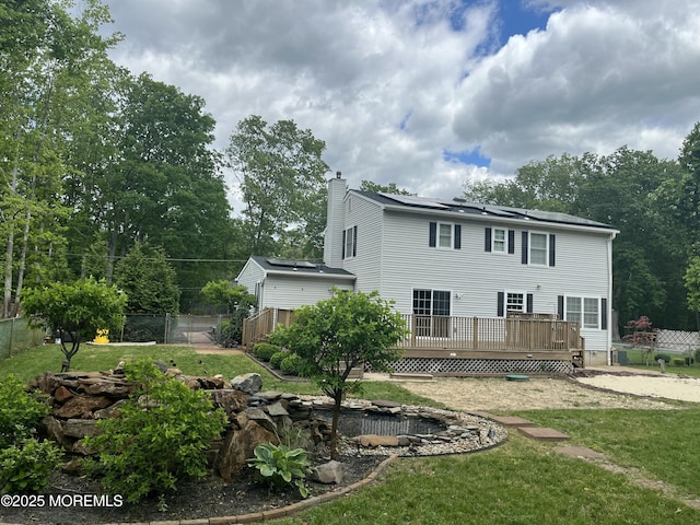 169 Docare Rd, Jackson, NJ 08527 - back of property with a chimney, a deck, and solar panels
