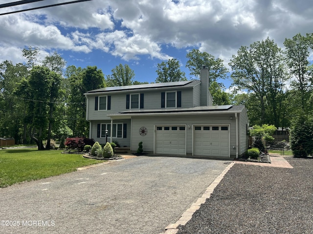 169 Docare Rd, Jackson, NJ 08527 - view of front of home featuring solar panels, driveway, a chimney, and a front lawn