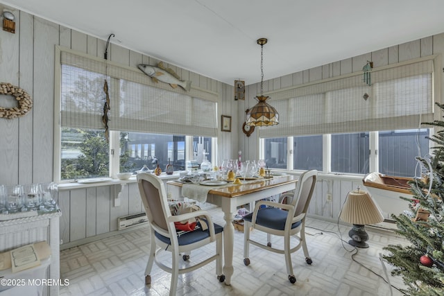 dining space with wood walls