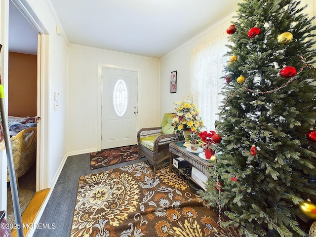 foyer entrance featuring ornamental molding and wood-type flooring