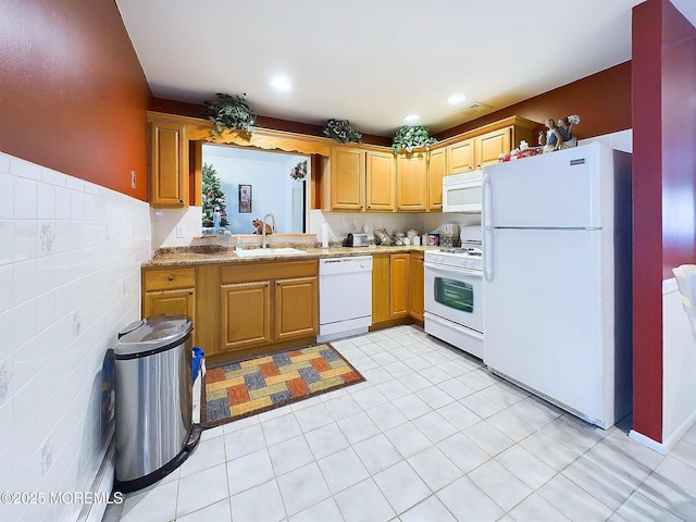 kitchen with sink, white appliances, and light tile patterned flooring