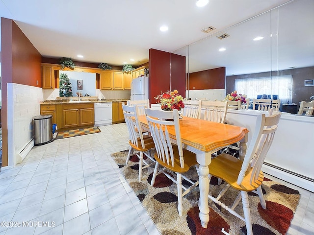 dining area featuring sink and a baseboard radiator