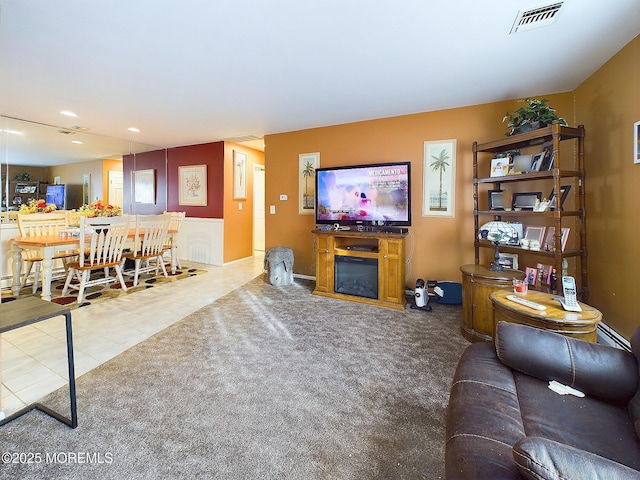 carpeted living room featuring a baseboard radiator