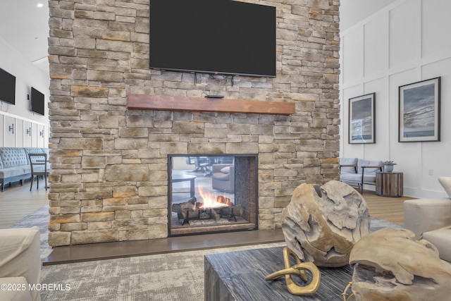 living room featuring hardwood / wood-style floors and a stone fireplace