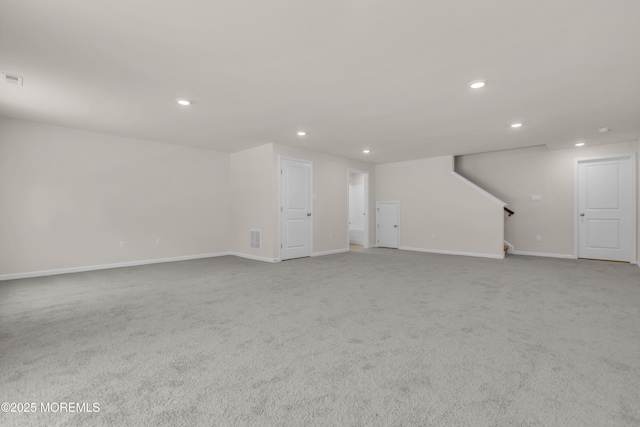 unfurnished living room featuring light colored carpet