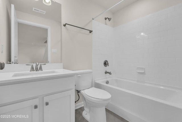 full bathroom featuring tiled shower / bath combo, toilet, and vanity