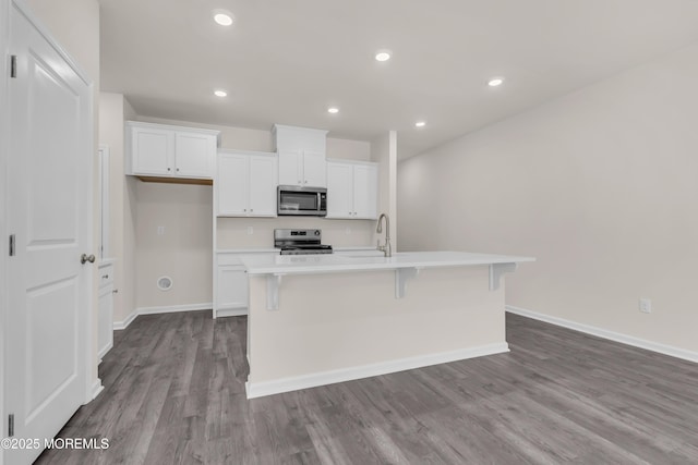 kitchen featuring white cabinetry, a kitchen island with sink, and appliances with stainless steel finishes