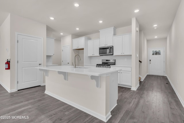 kitchen featuring sink, white cabinets, a center island with sink, and appliances with stainless steel finishes