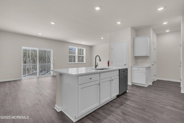 kitchen with dishwasher, dark wood-type flooring, white cabinetry, sink, and a center island with sink