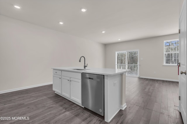 kitchen with dishwasher, white cabinets, sink, dark hardwood / wood-style flooring, and an island with sink