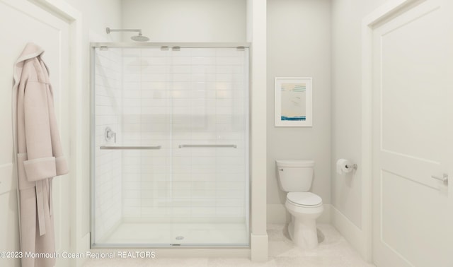 bathroom with toilet and an enclosed shower