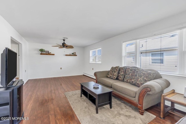 living room with a baseboard heating unit, hardwood / wood-style flooring, and ceiling fan