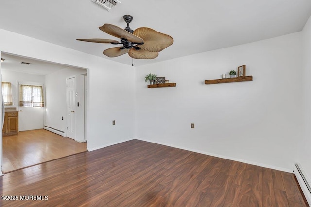 spare room featuring a baseboard radiator, hardwood / wood-style floors, and ceiling fan