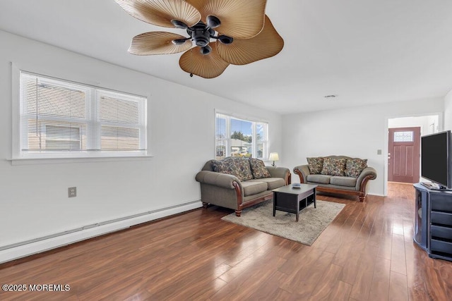 living room with ceiling fan, dark hardwood / wood-style flooring, and a baseboard heating unit