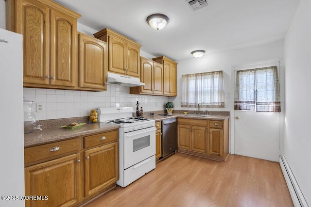 kitchen with sink, white appliances, light hardwood / wood-style flooring, baseboard heating, and backsplash