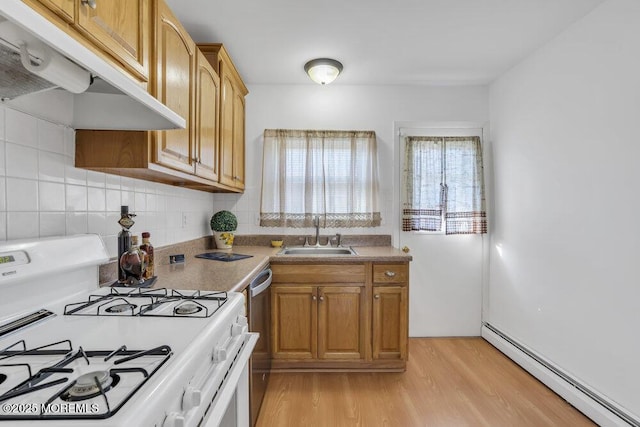 kitchen with sink, light wood-type flooring, stainless steel dishwasher, white gas range, and a baseboard heating unit