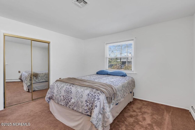 carpeted bedroom featuring a baseboard radiator and a closet