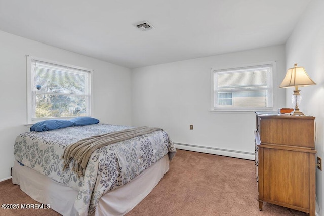 carpeted bedroom featuring a baseboard heating unit