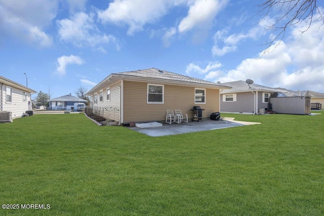 back of property with a patio, a yard, and central air condition unit