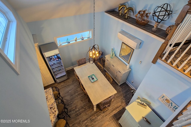 living room featuring a notable chandelier and dark hardwood / wood-style flooring