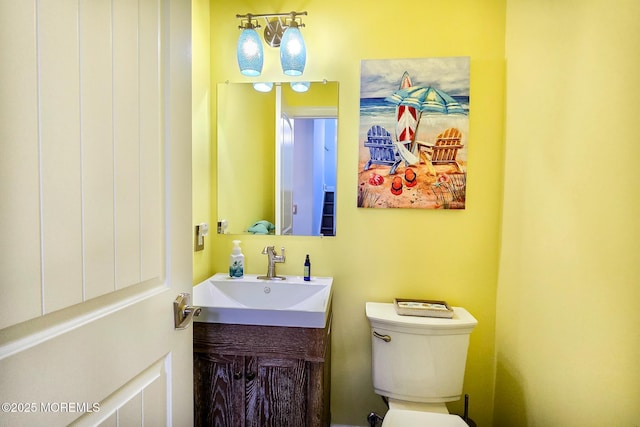 bathroom featuring toilet and vanity