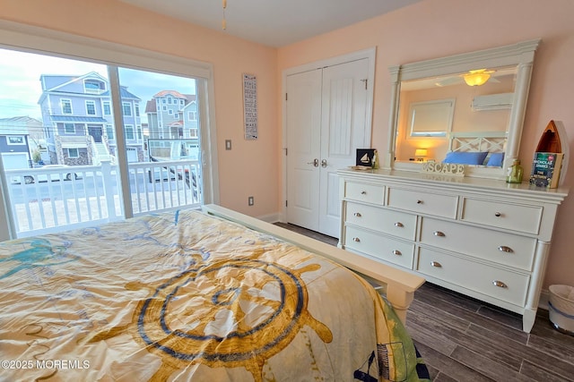 bedroom with a closet, access to outside, and a wall mounted air conditioner