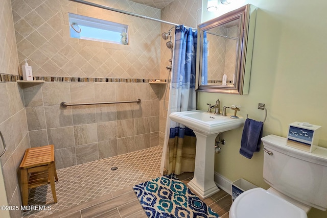 bathroom with toilet and a shower with curtain